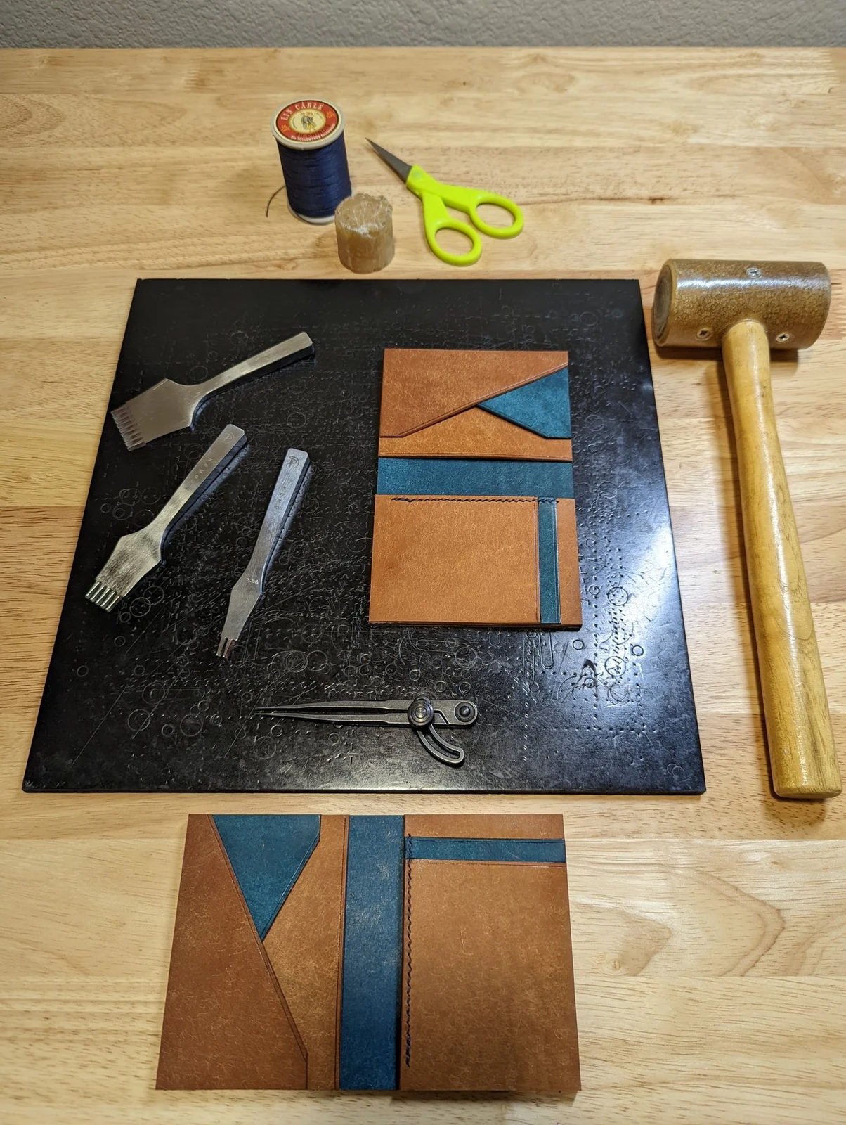 Cut wallet panels and tools laid out before assembly